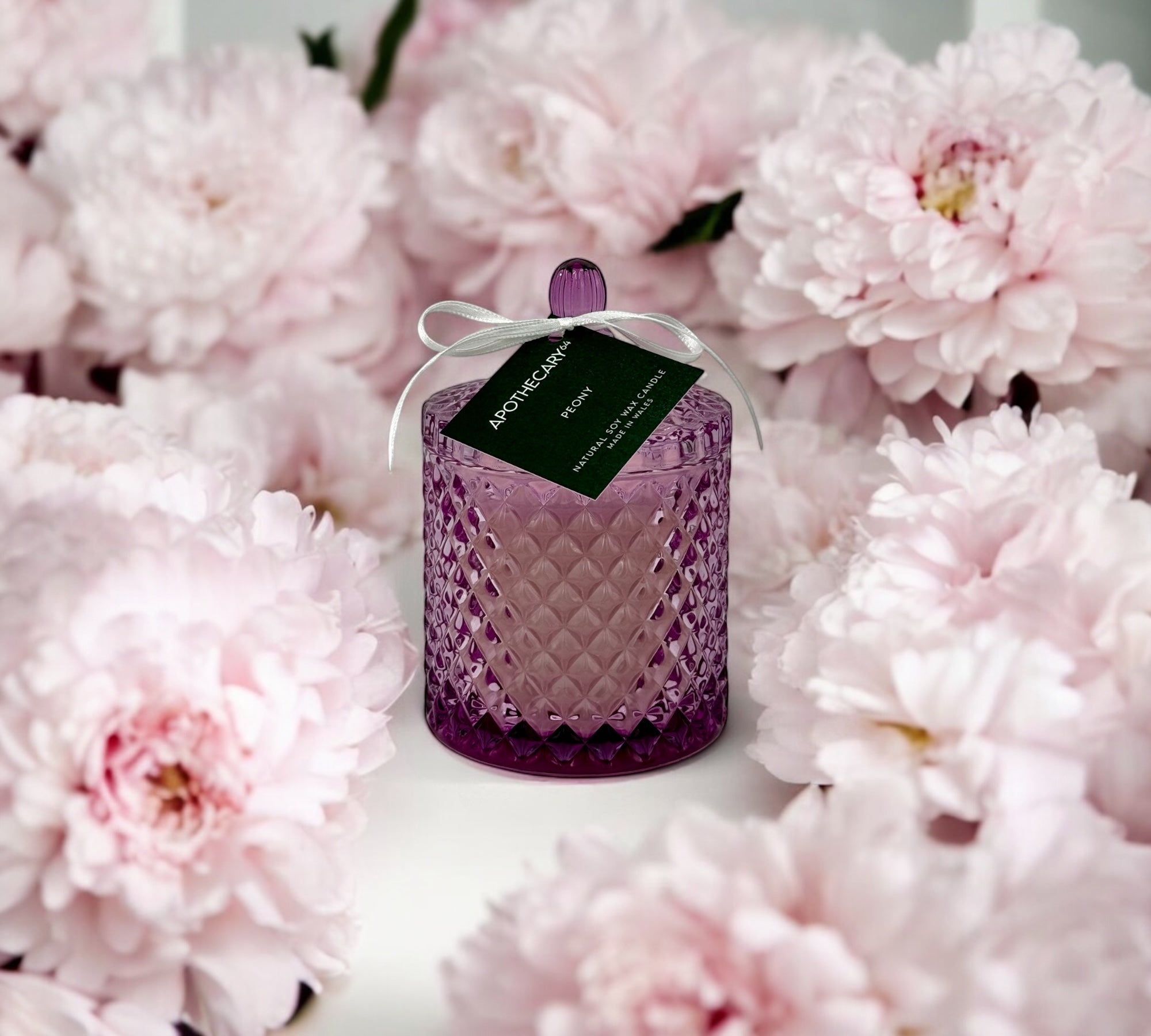 "Collection of ornate glass jar candles with metallic lids"